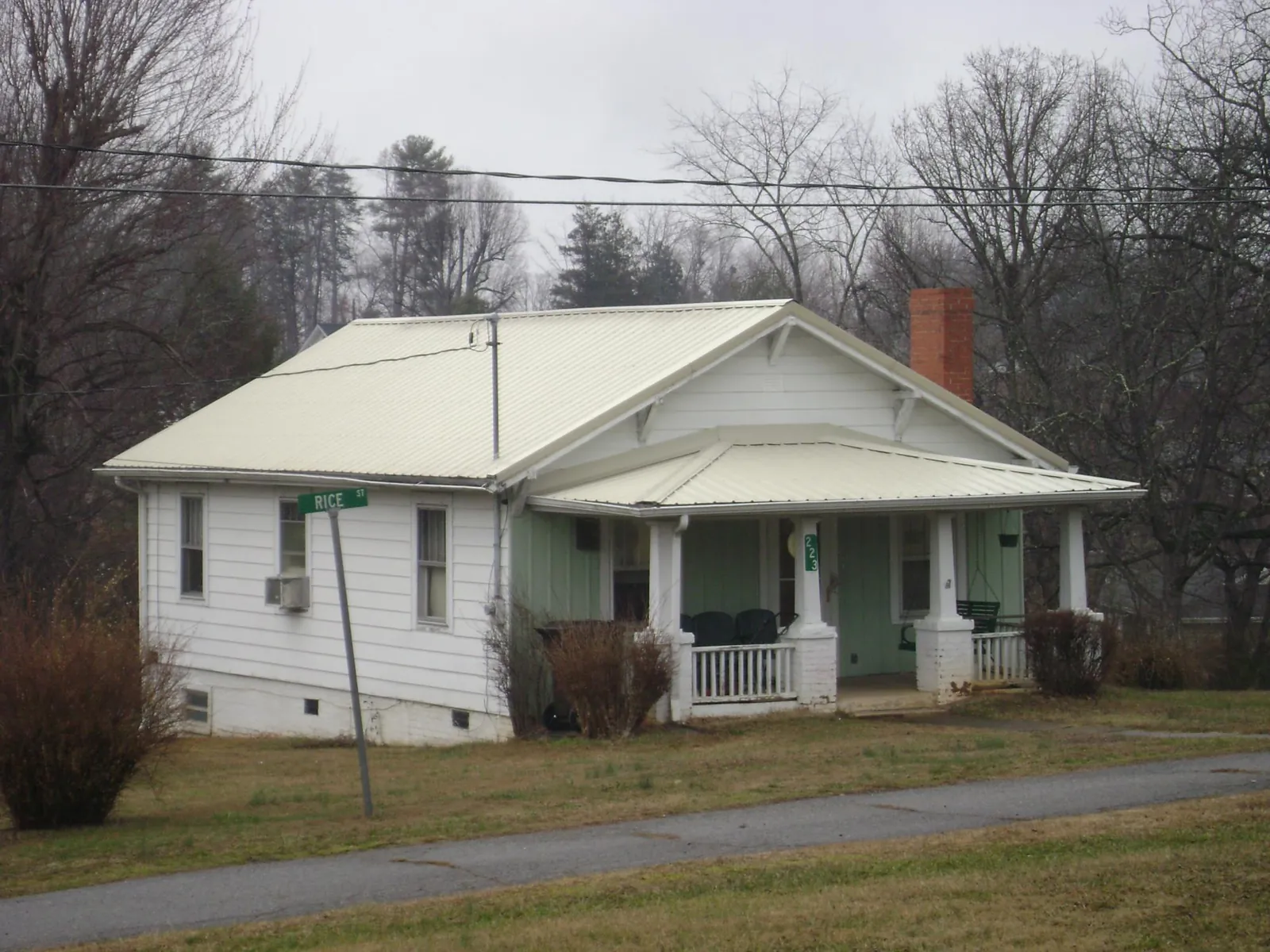 White metal roof on a craftsman bungalow at a street corner in West Oneonta